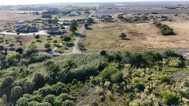 an aerial view of a house with a yard and outdoor seating