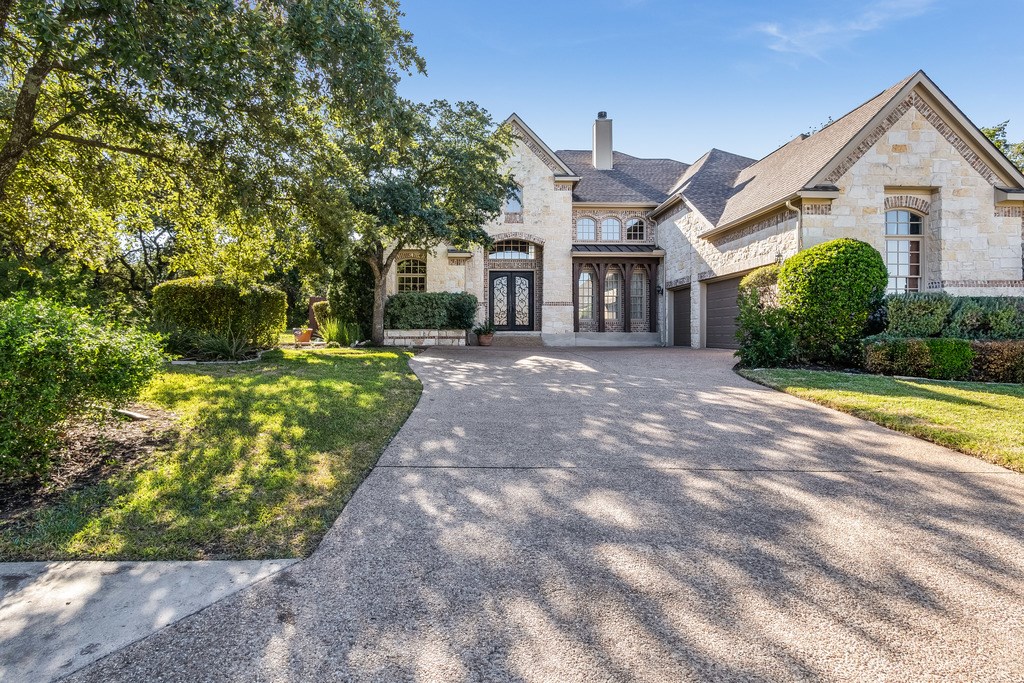 3008 Napa Drive Austin, TX 78738 - Photo 1 of 1 a front view of a house with a yard and potted plants