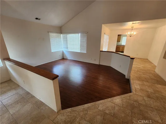 an entryway with wooden floor and windows