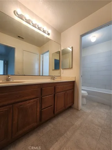 a spacious bathroom with a granite countertop sink mirror and double