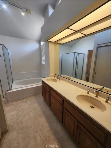a bathroom with a tub sink and mirror