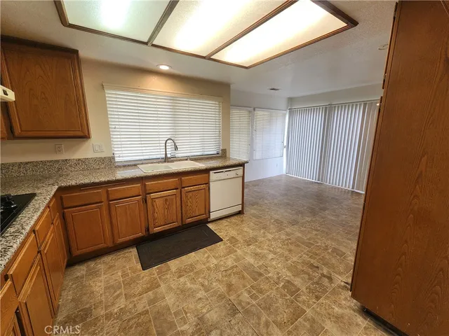 a kitchen with stainless steel appliances granite countertop a sink and cabinets
