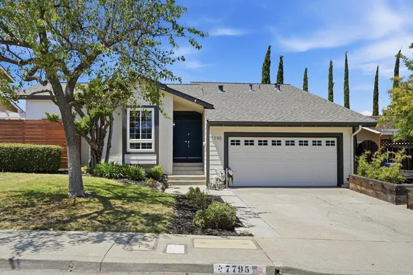a front view of house with garage and yard