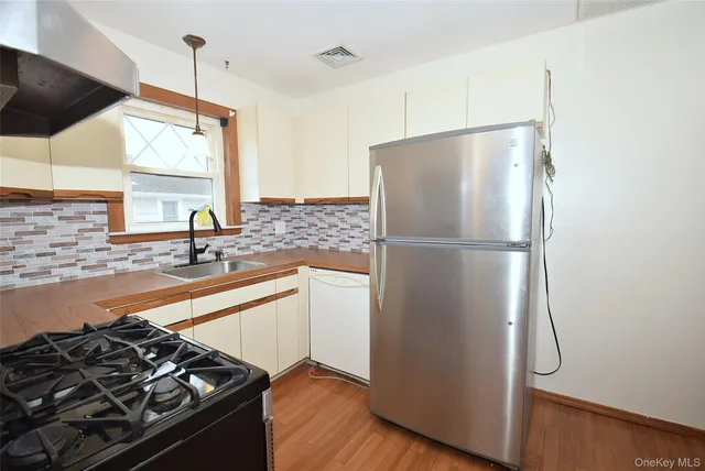 a kitchen with a refrigerator and a sink