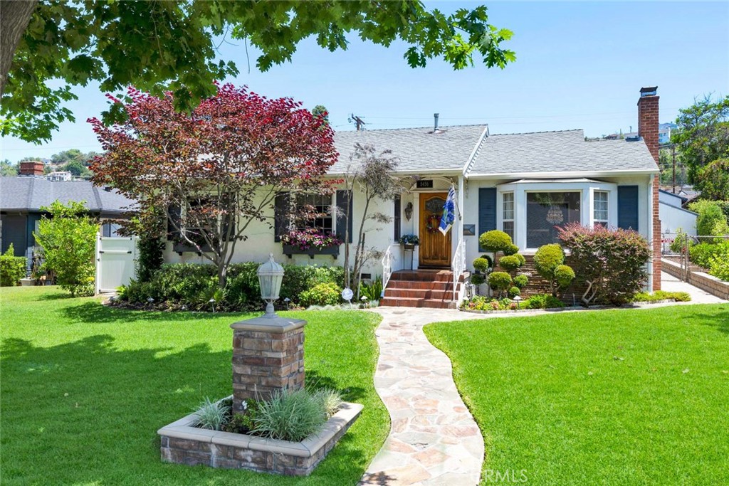 5456 Cadbury Road Whittier, CA 90601 - Photo 3 of 67 a front view of a house with a yard garden and outdoor seating