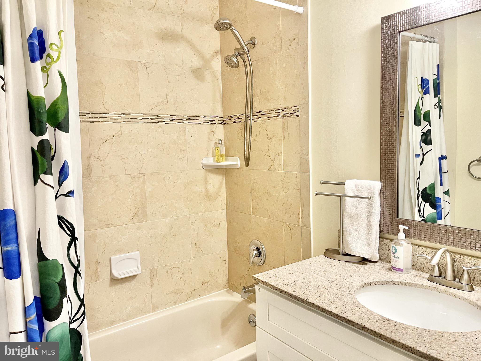 302 Marten Road Princeton, NJ 08540 - Photo 13 of 22 a bathroom with a granite countertop sink a mirror a bathtub and shower