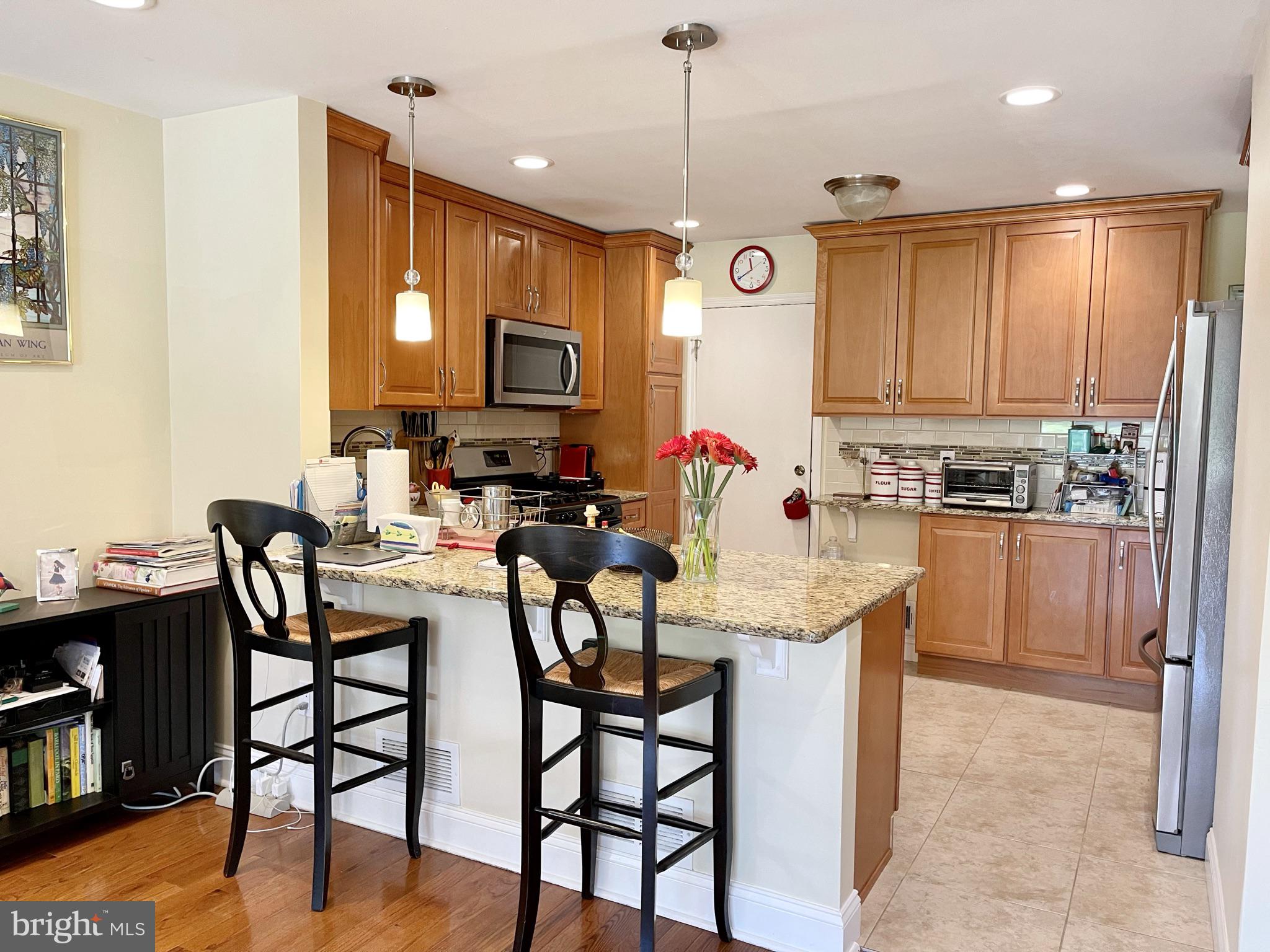 302 Marten Road Princeton, NJ 08540 - Photo 6 of 22 a kitchen with kitchen island a dining table chairs and a refrigerator