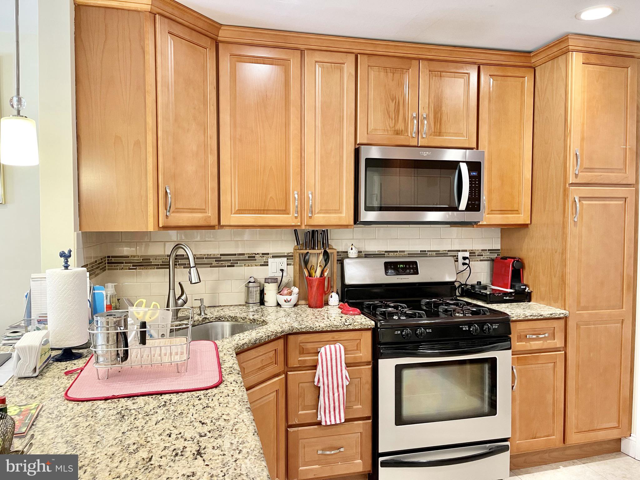 302 Marten Road Princeton, NJ 08540 - Photo 8 of 22 a kitchen with stainless steel appliances granite countertop a stove a microwave and cabinets