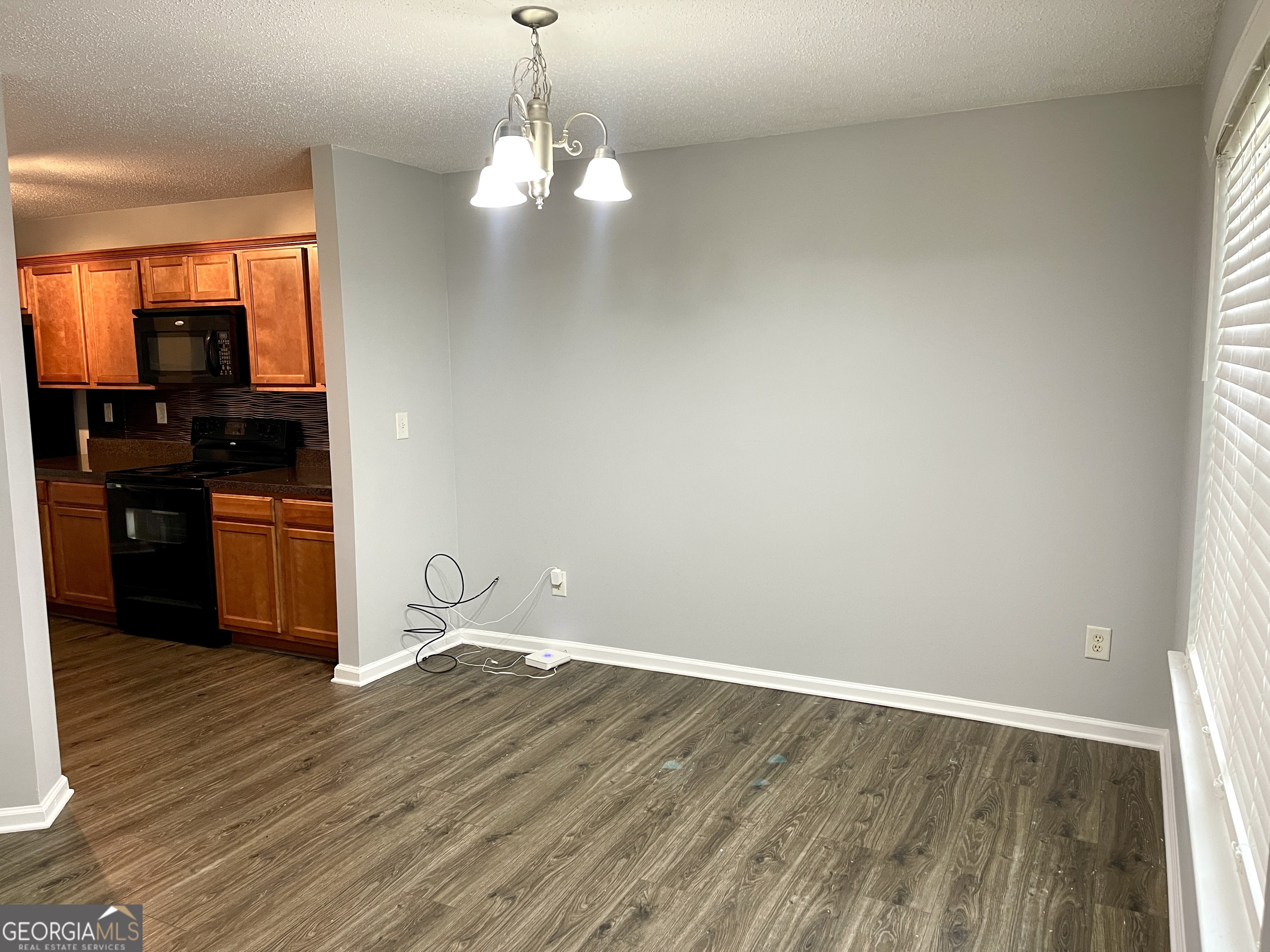 101 Prattling Court Atlanta, GA 30349 - Photo 2 of 16 a view of a kitchen with wooden floor and cabinets