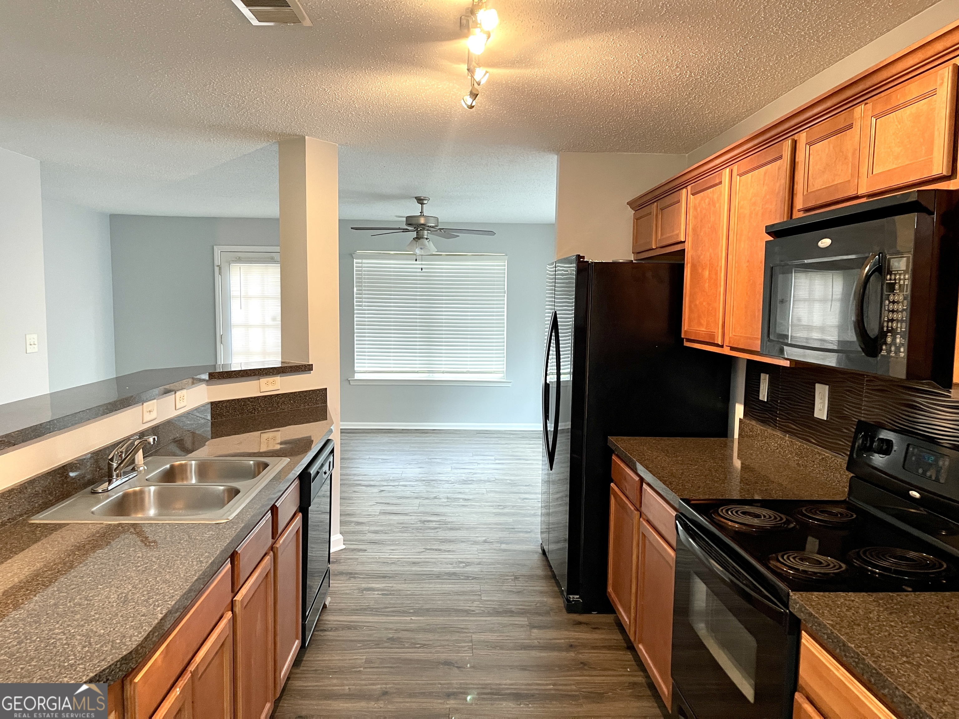 101 Prattling Court Atlanta, GA 30349 - Photo 4 of 16 a kitchen with stainless steel appliances granite countertop a stove a sink and a microwave