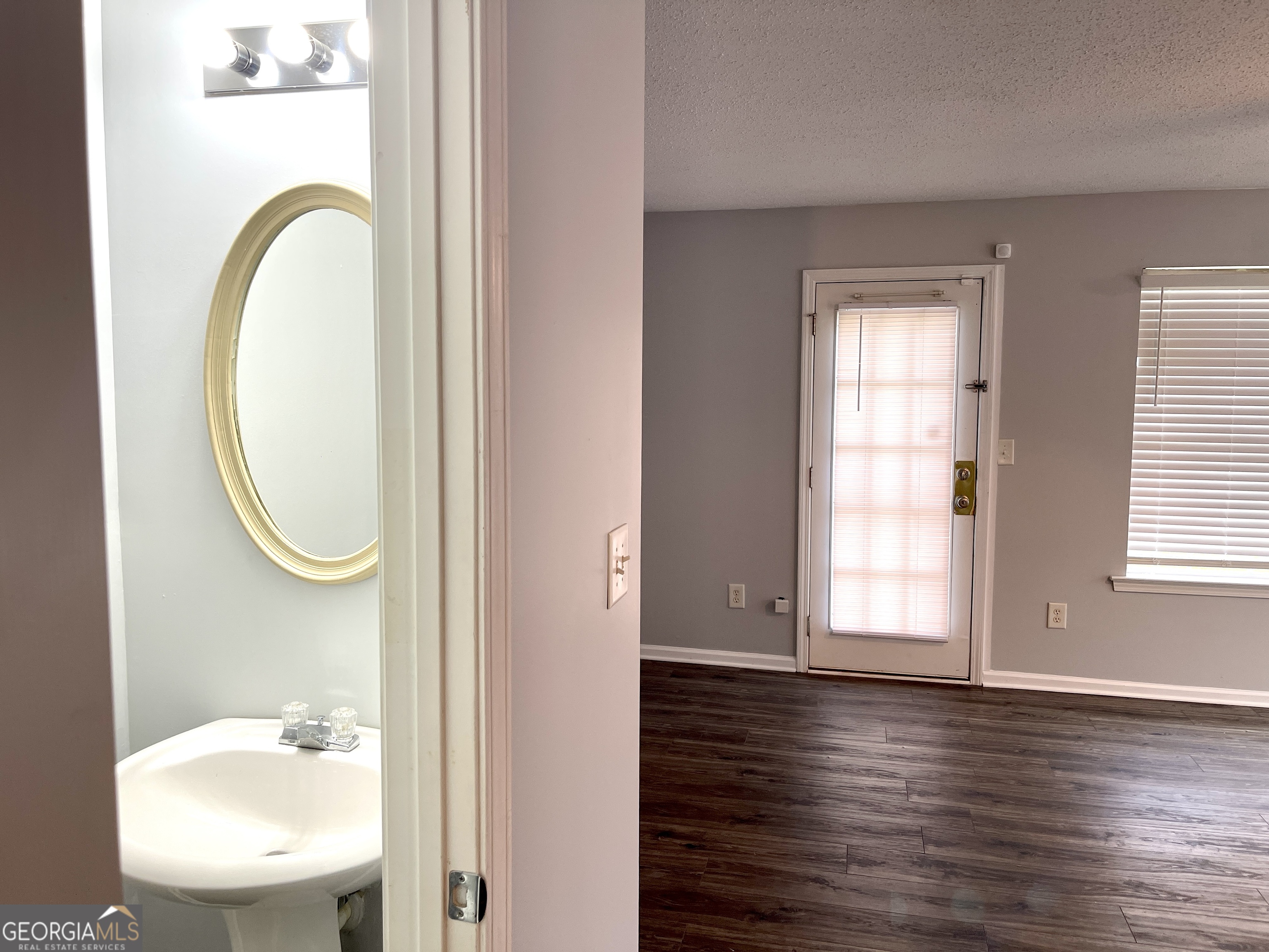 101 Prattling Court Atlanta, GA 30349 - Photo 8 of 16 a bathroom with a toilet a sink and a mirror