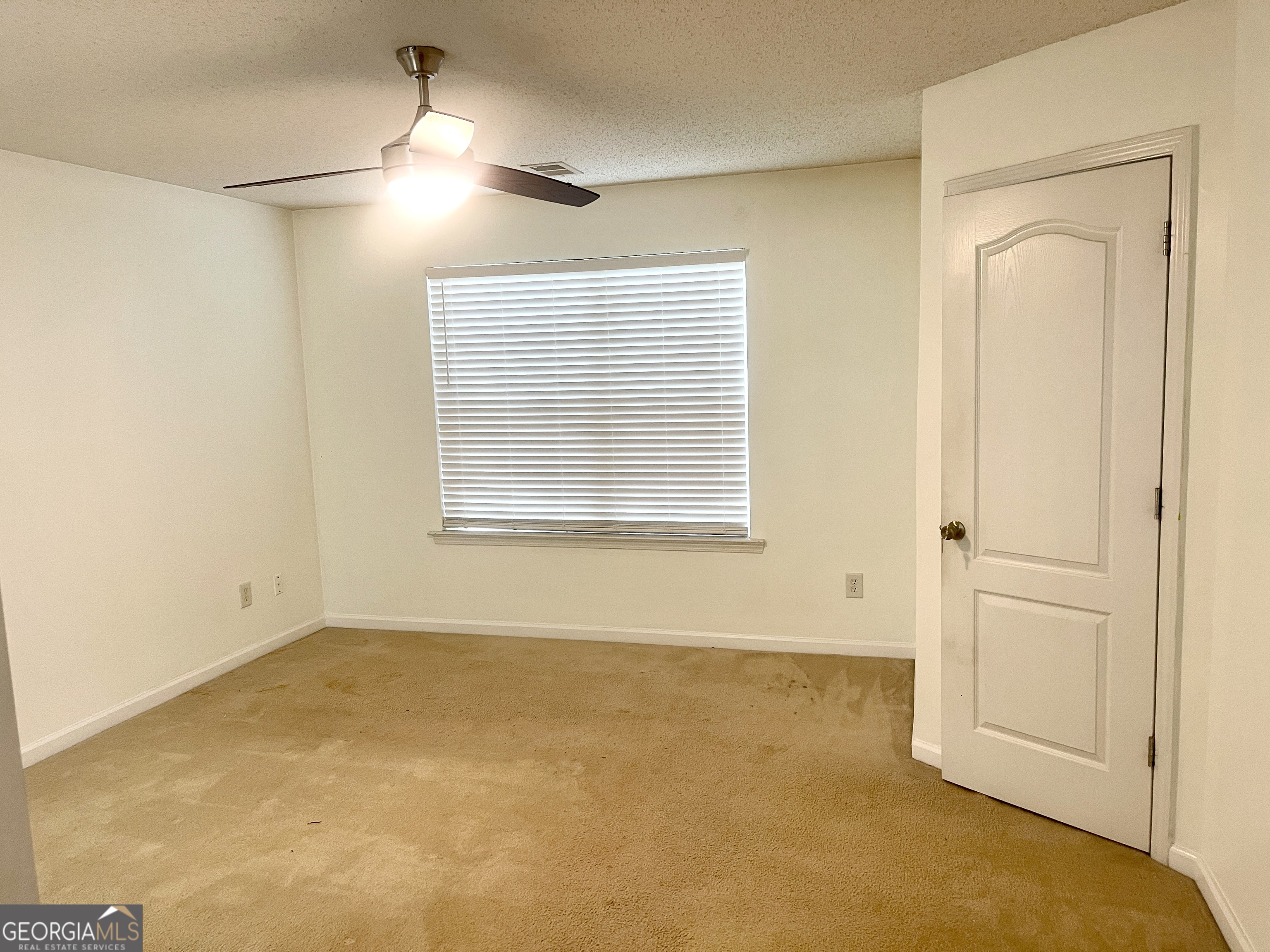 101 Prattling Court Atlanta, GA 30349 - Photo 9 of 16 an empty room with windows