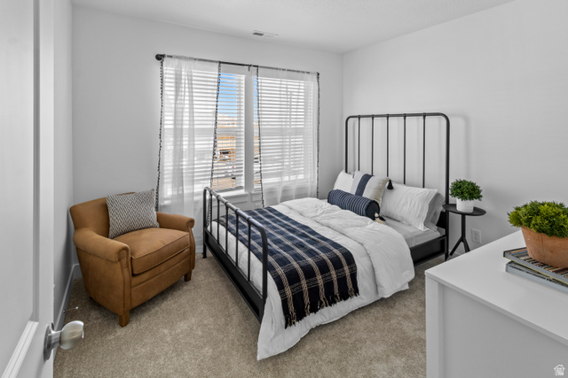 1264 West 500 South, Unit 320 Logan, UT 84321 - Photo 23 of 39 Room featuring light gray carpeting, neutral wall paint, and a window with blinds and sheer curtains