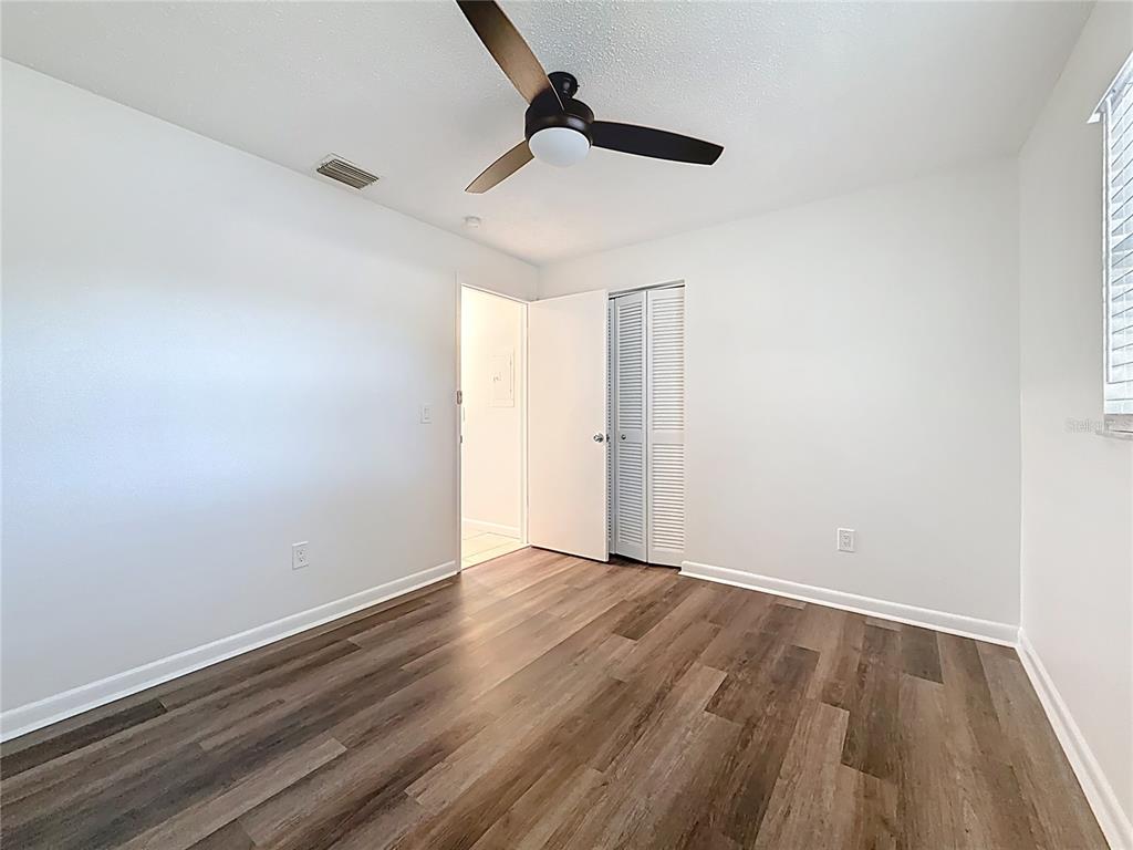 650 Athens Street Dunedin, FL 34698 - Photo 11 of 39 a view of an empty room with wooden floor