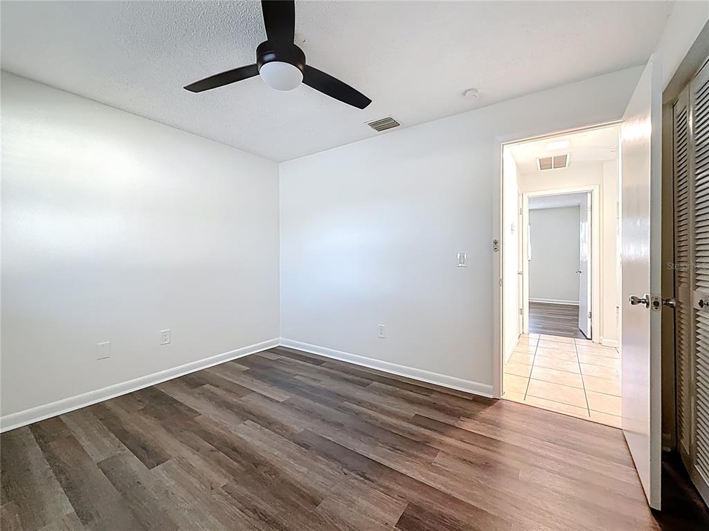 650 Athens Street Dunedin, FL 34698 - Photo 12 of 39 a view of an empty room with wooden floor