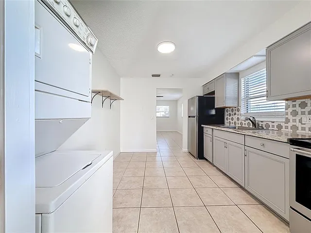 a kitchen with stainless steel appliances a refrigerator sink and cabinets