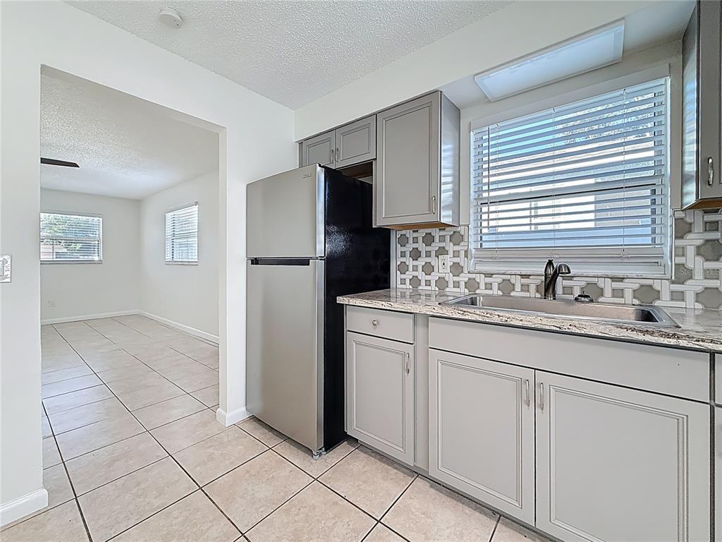 650 Athens Street Dunedin, FL 34698 - Photo 15 of 39 a kitchen with sink and refrigerator