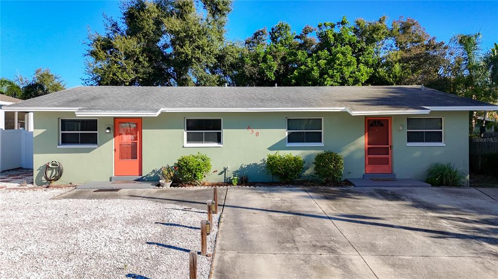 650 Athens Street Dunedin, FL 34698 - Photo 2 of 39 a front view of a house with garden