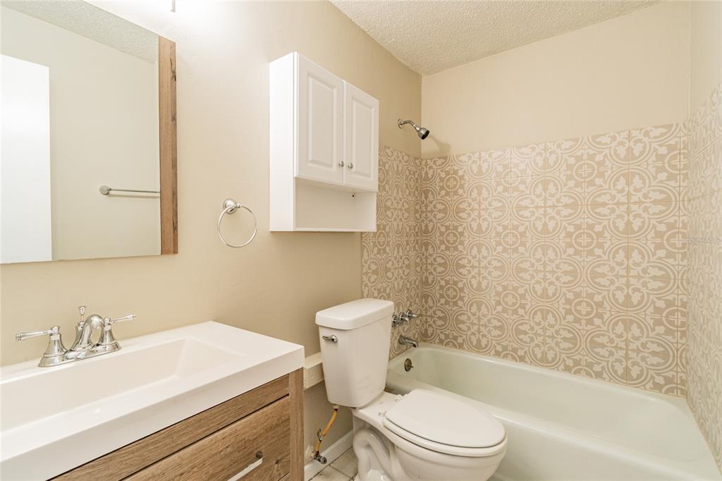 650 Athens Street Dunedin, FL 34698 - Photo 26 of 39 a bathroom with a sink a toilet and shower
