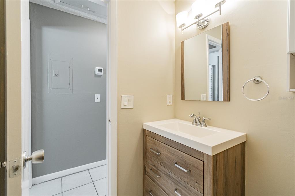 650 Athens Street Dunedin, FL 34698 - Photo 27 of 39 a bathroom with a sink and a mirror