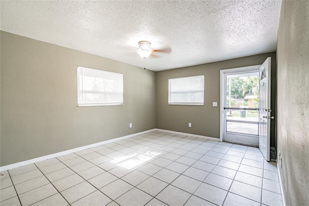 650 Athens Street Dunedin, FL 34698 - Photo 30 of 39 a view of an empty room with window and cabinet area