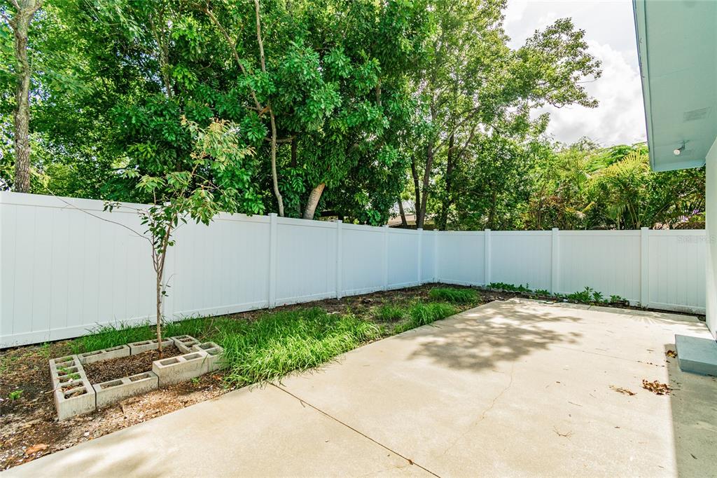 650 Athens Street Dunedin, FL 34698 - Photo 35 of 39 a backyard of a house with lots of green space