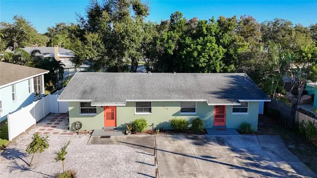an aerial view of a house with yard swimming pool and outdoor seating