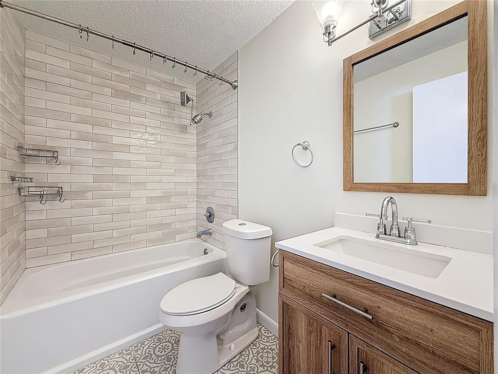 650 Athens Street Dunedin, FL 34698 - Photo 5 of 39 a bathroom with a sink a toilet and a bathtub