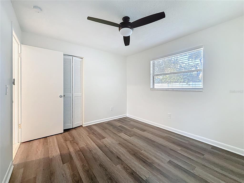 650 Athens Street Dunedin, FL 34698 - Photo 10 of 39 a view of empty room with wooden floor