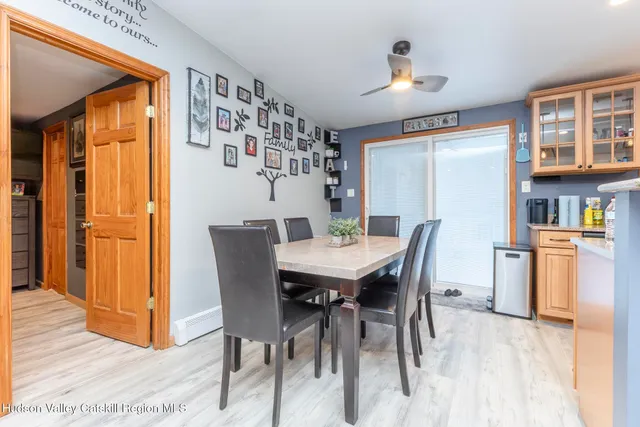 a view of a dining room with furniture and a chandelier