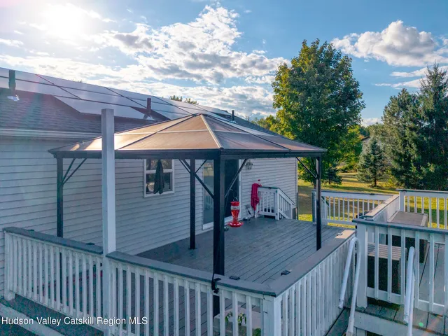 a view of a swimming pool with a patio and a yard