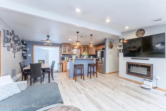 a dining room with kitchen island furniture and a flat screen tv