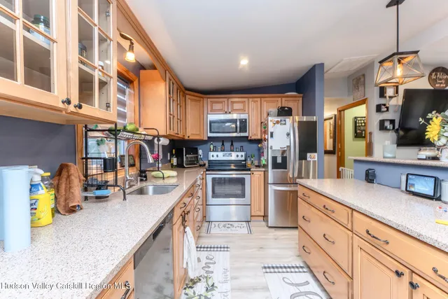 a kitchen with stainless steel appliances granite countertop sink stove and cabinets