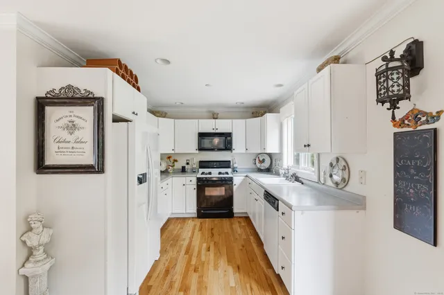a kitchen with stainless steel appliances granite countertop a refrigerator and a stove