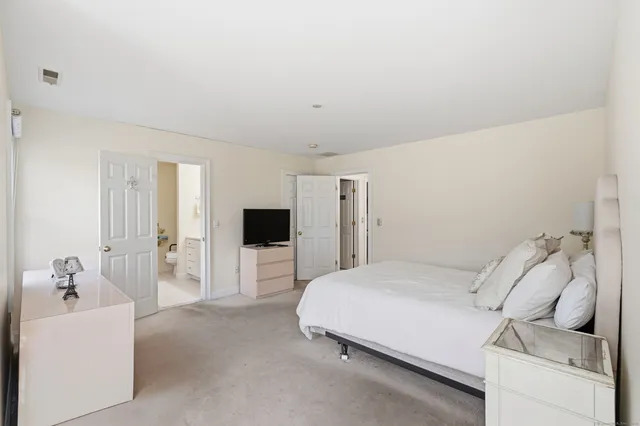 a bedroom with a bed and a couch