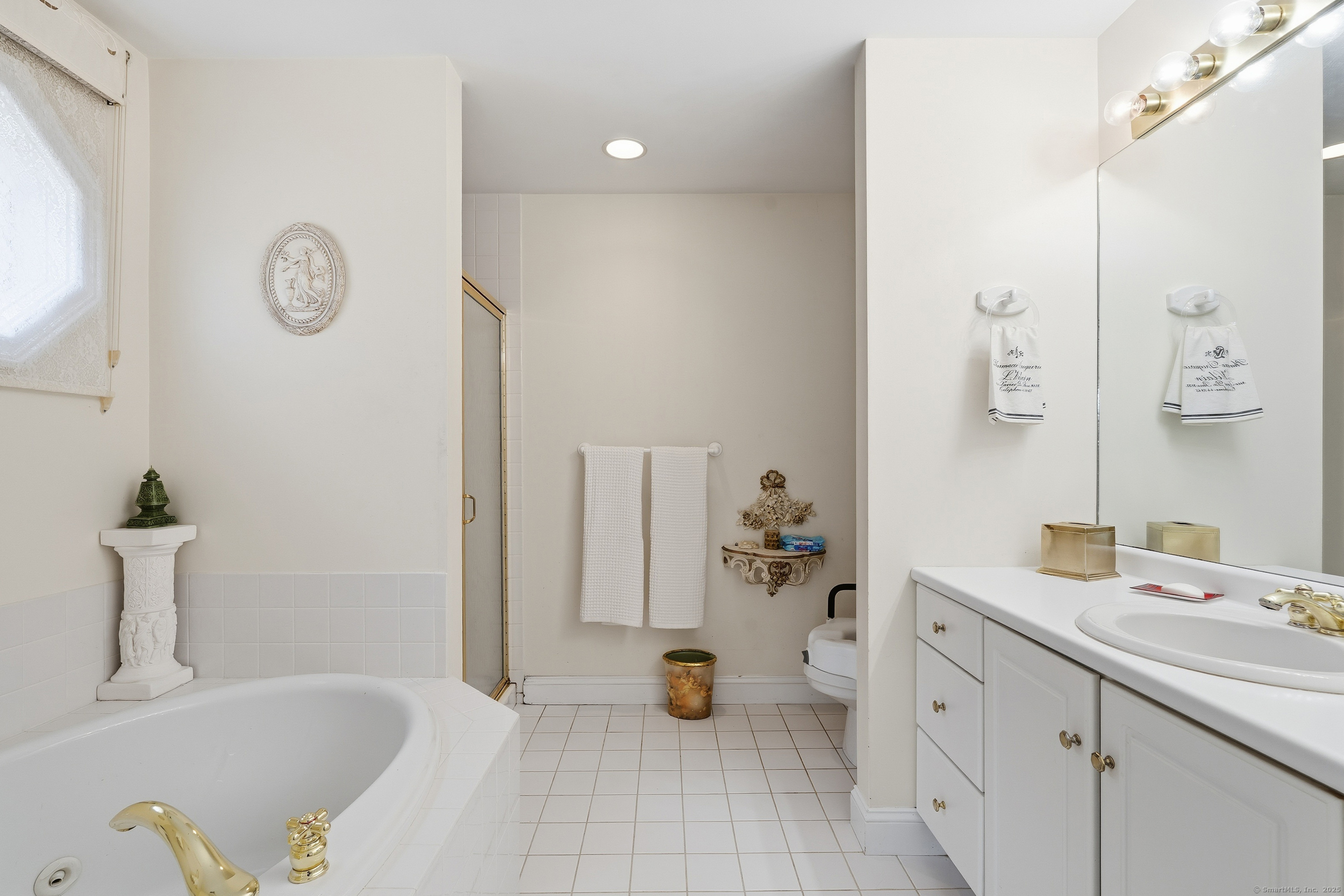 59 Prospect Street, Unit C Ridgefield, CT 06877 - Photo 22 of 38 a bathroom with a tub sink and mirror with toilet