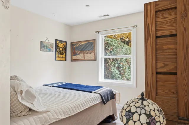 a bedroom with a bed and a window