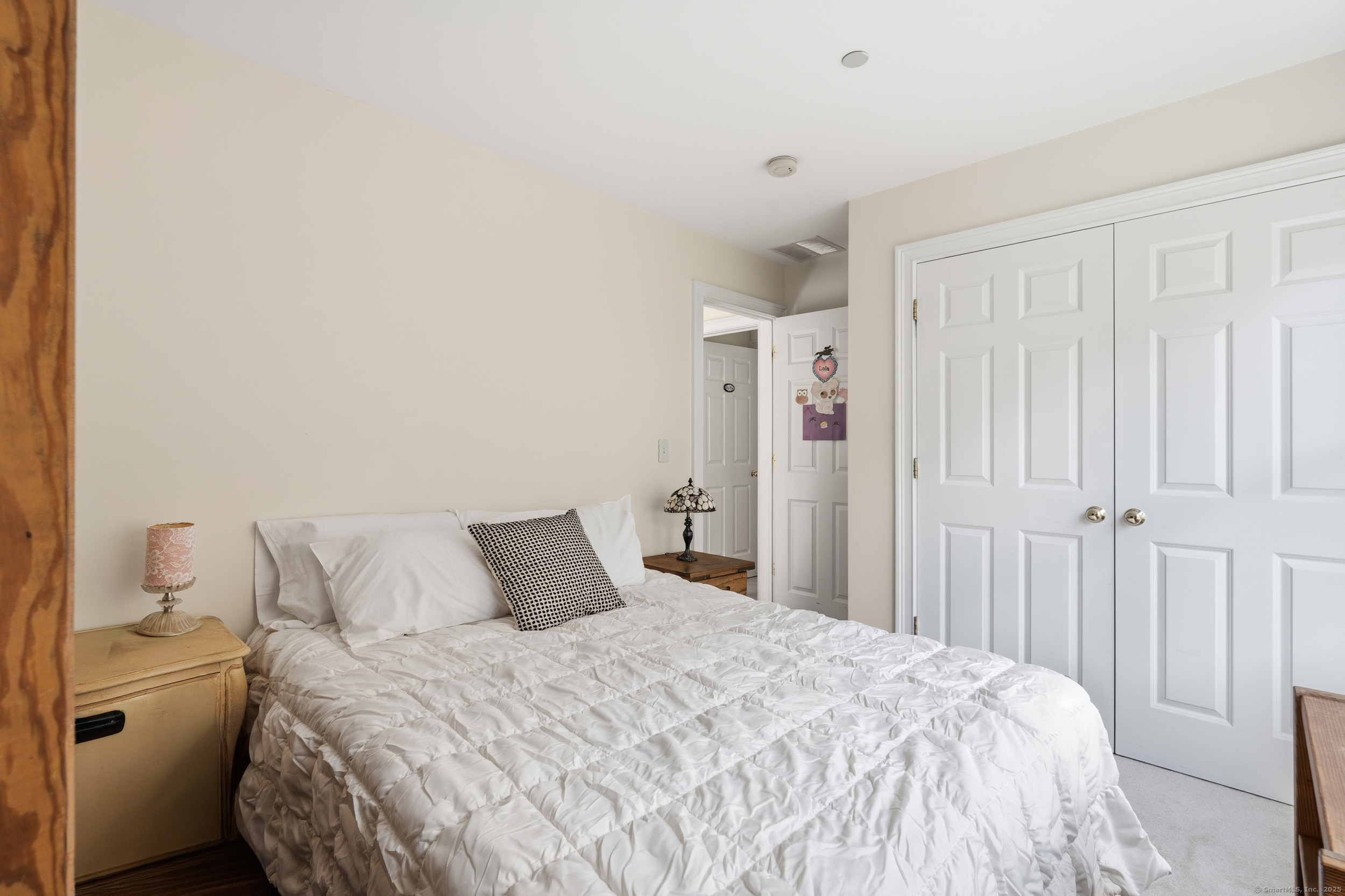 59 Prospect Street, Unit C Ridgefield, CT 06877 - Photo 28 of 38 a bedroom with a bed and a window