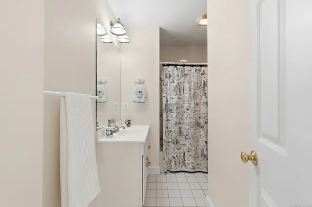 a bathroom with a bathtub sink and mirror