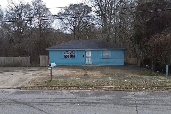 a house with trees in the background