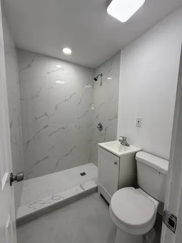 an empty room with staircase and white walls