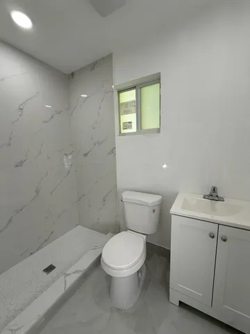 a view of a livingroom with furniture and windows