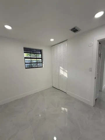 a large space with a large window and stainless steel appliances