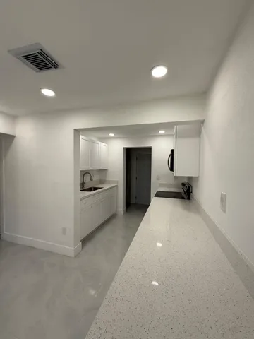 a bathroom with a sink and a large mirror