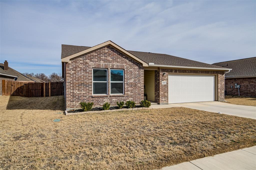905 Avagail Avenue Springtown, TX 76082 - Photo 2 of 26 Ranch-style house with roof with shingles, driveway, brick siding, and a garage