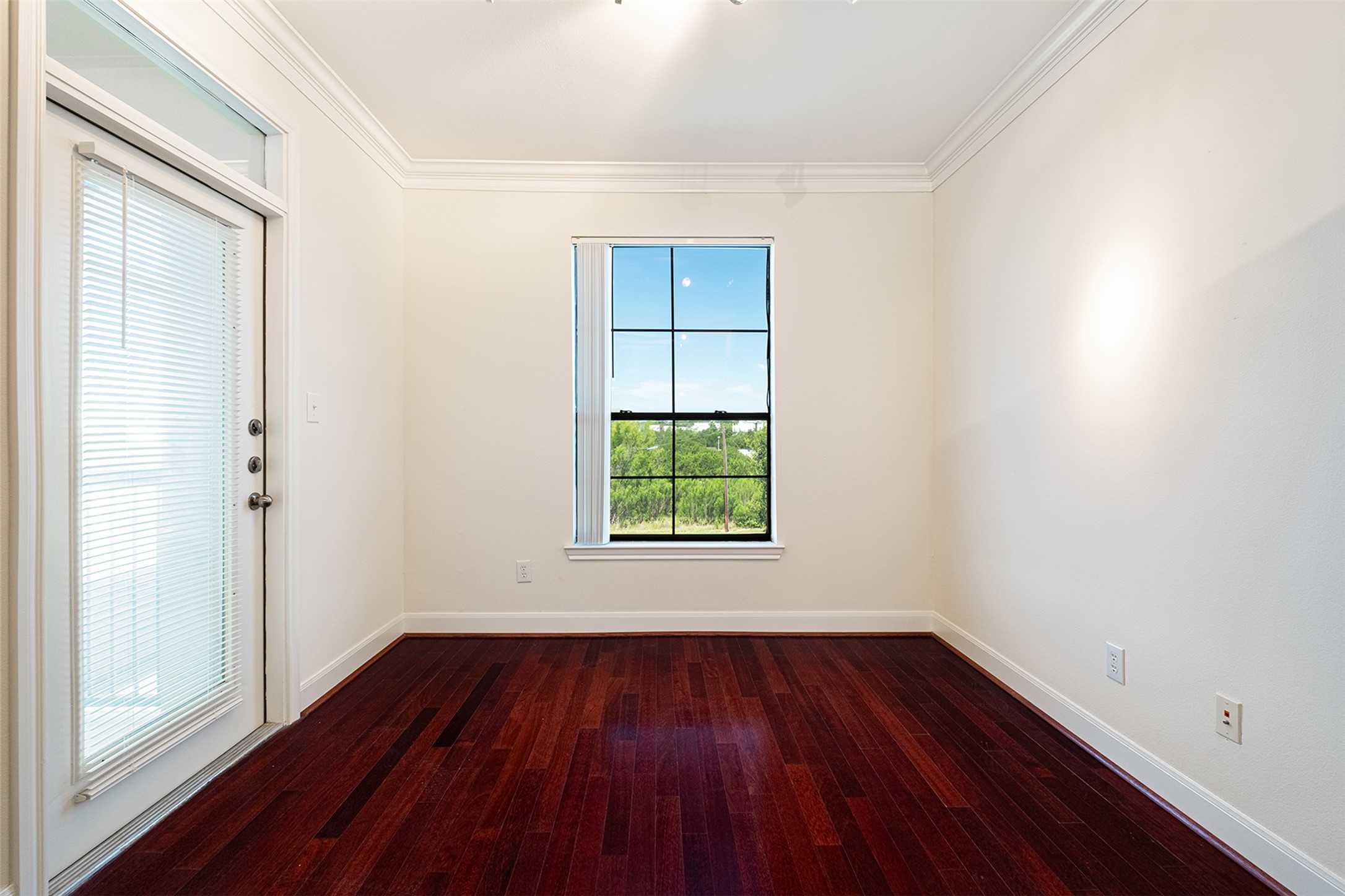 7701 Rialto Boulevard, Unit 637 Austin, TX 78735 - Photo 8 of 25 Rich hardwood floors complement this versatile room, perfect for an office or guest space.