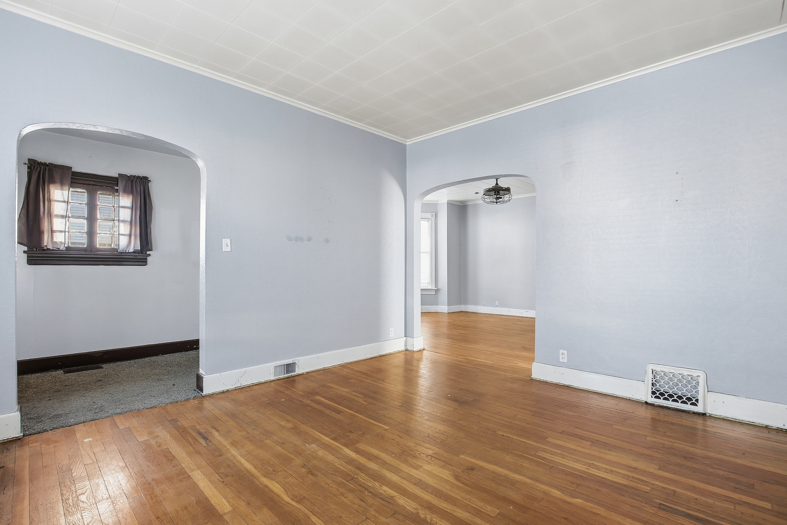 2115 West 4th Street Davenport, IA 52802 - Photo 11 of 24 an empty room with wooden floor and windows