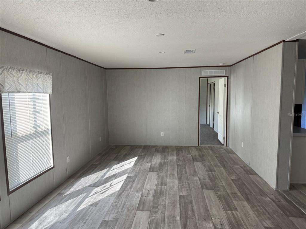 1561 Poe Road Lake Wales, FL 33898 - Photo 3 of 15 a view of wooden floor in an empty room