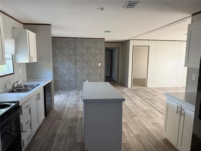 a kitchen with a sink stove and refrigerator