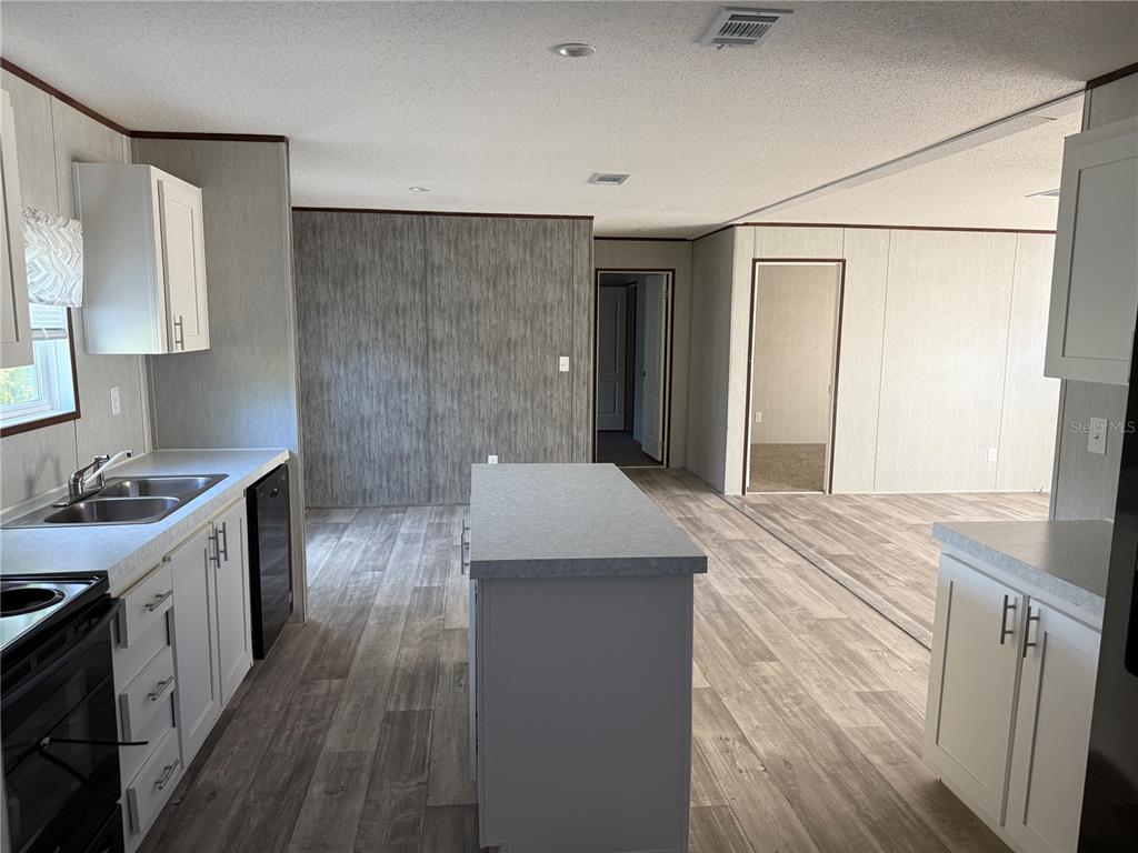 1561 Poe Road Lake Wales, FL 33898 - Photo 4 of 15 a kitchen with a sink stove and refrigerator